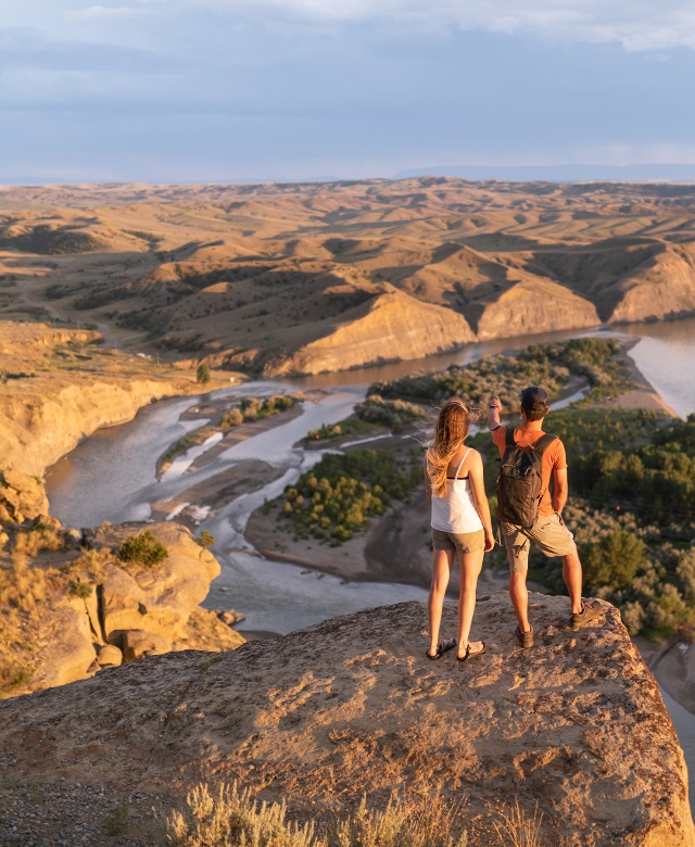 A couple standing on the Rimrocks in Billings overlooking the winding Yellowstone River
