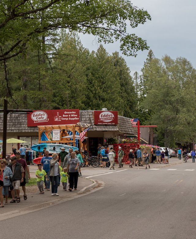 A view down a tourist filled shop street in Apgar