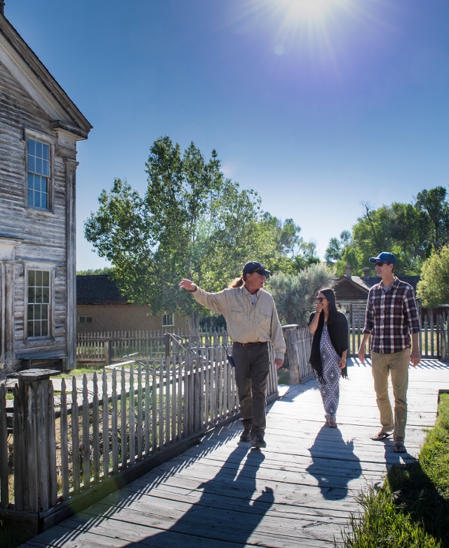 A group of people walking the boardwalk in Bannack State Park