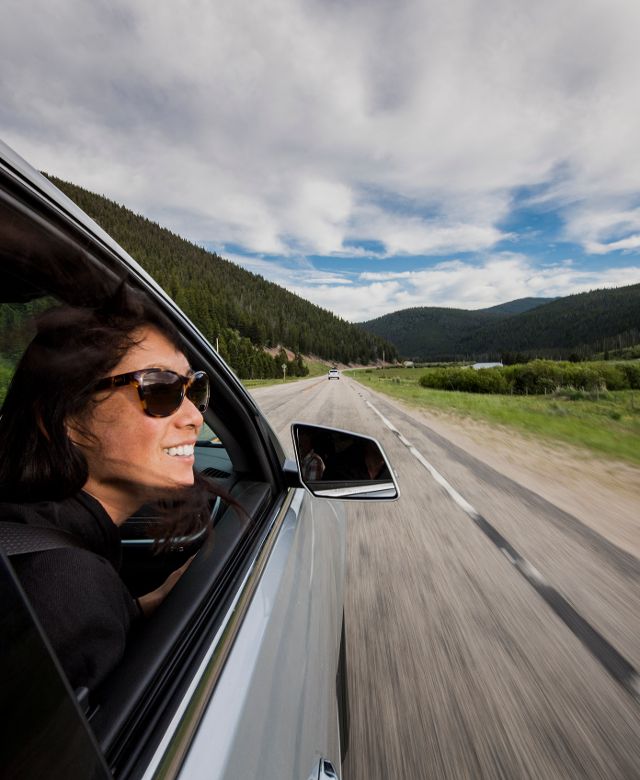woman looking out the window of a moving car