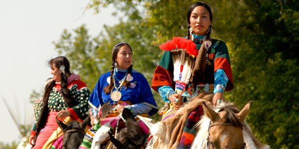 native women riding horses