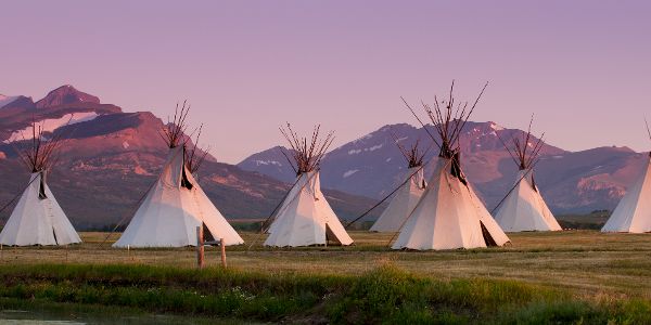 teepees under purple sky