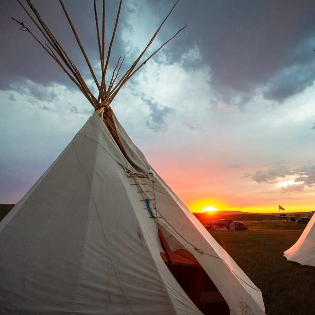 scenic view of teepees during sunset