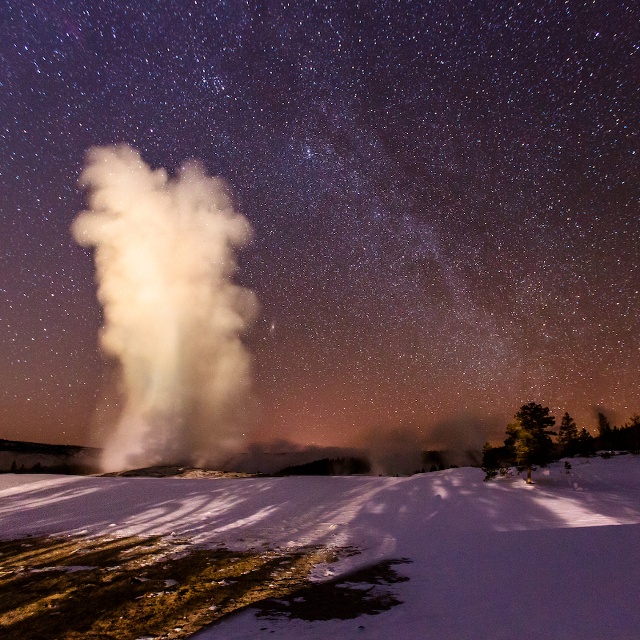 image of Old Faithful geyser at night