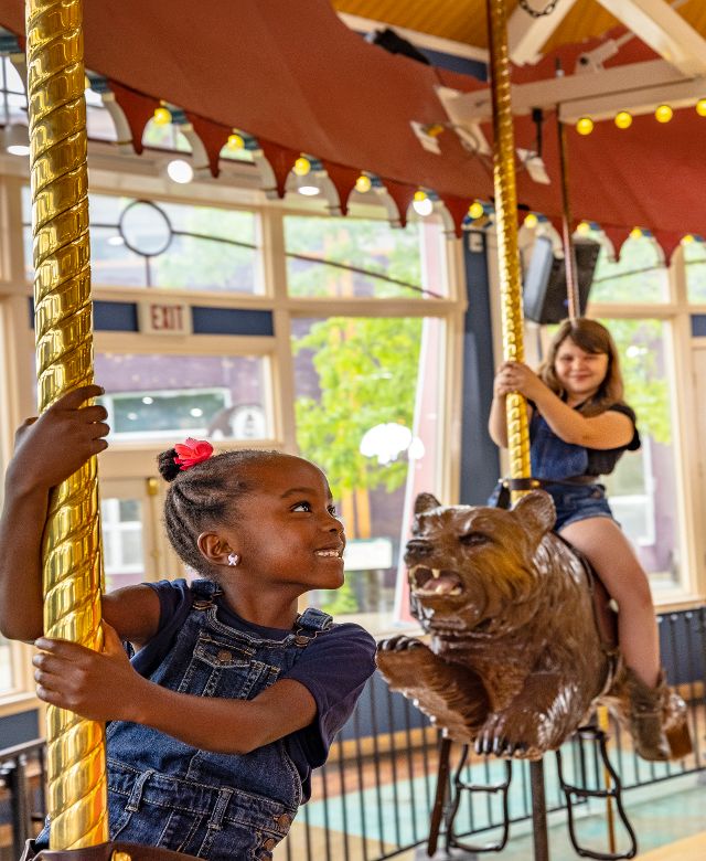 Mom and daughter on carousel