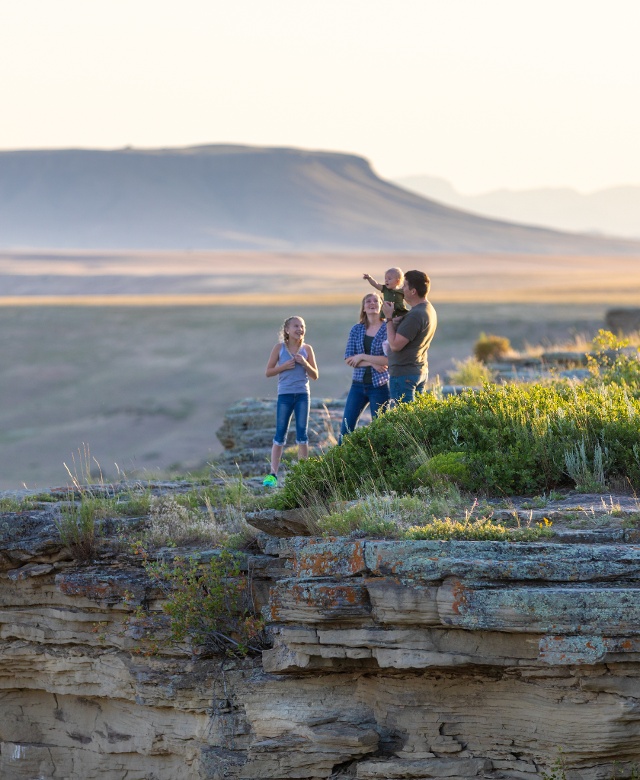A family of four overlooking First Peoples Buffalo Jump State Park