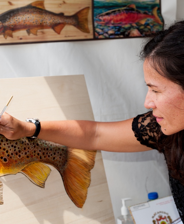 Woman painting canvas at the Butte Folk Festival