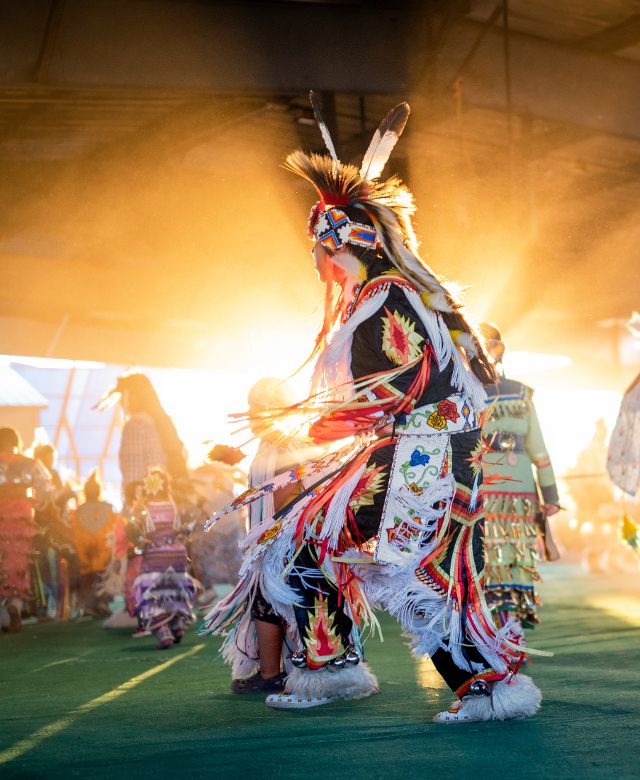 Powwow participant dancing in full regalia