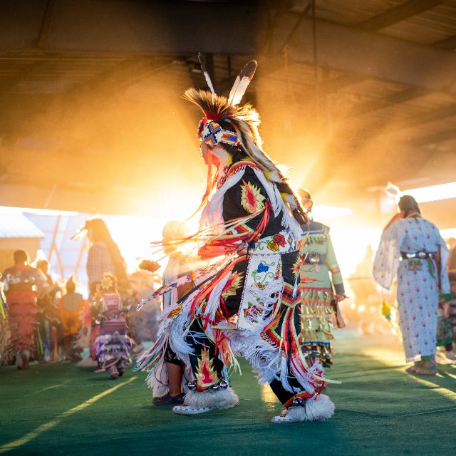 Powwow participant dancing in full regalia