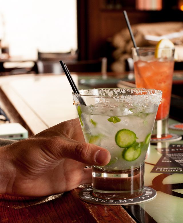 A hand holding a cocktail at Trailhead Spirits in Billings