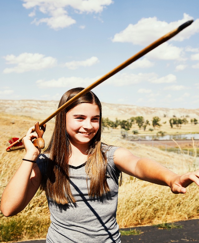 Girl throwing arrow at Buffalo Jump State Park