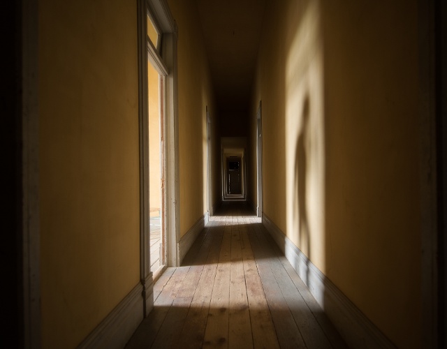 looking down shadowy hallway