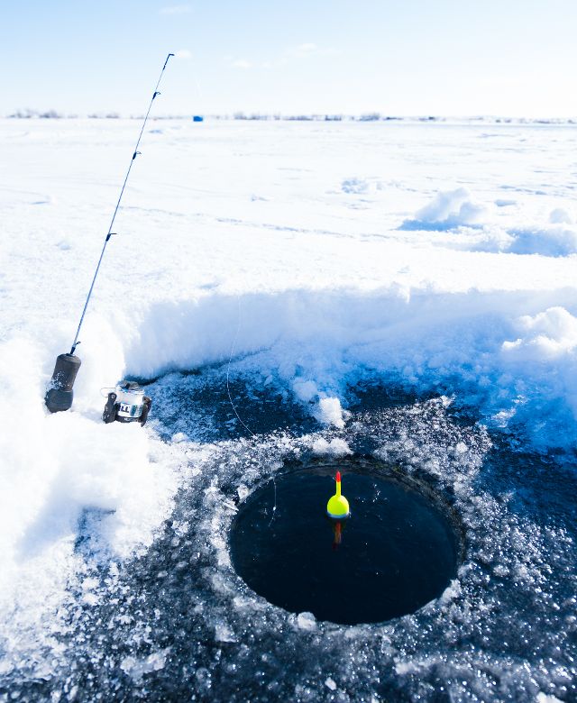 A hole cut in the ice for ice fishing
