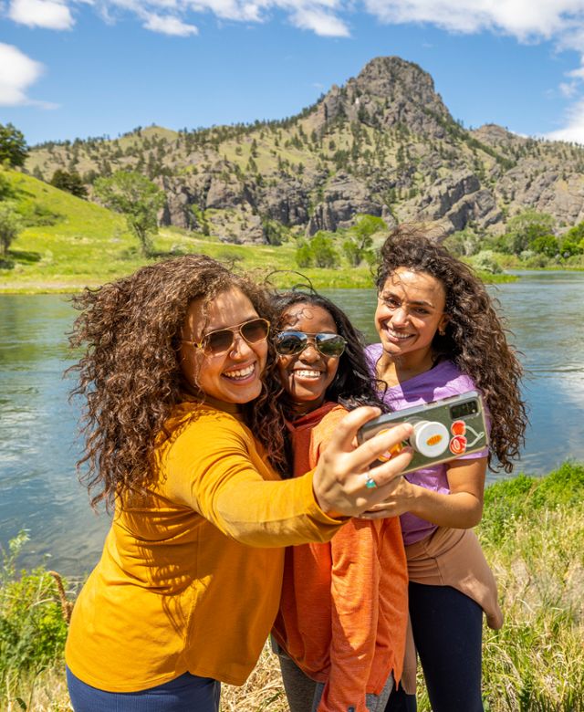 Three friends pose for a selfie in front of the Missouri River in Central Montana