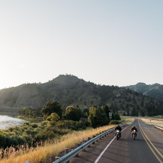 two people riding motorcycles past Tower Rock State Park