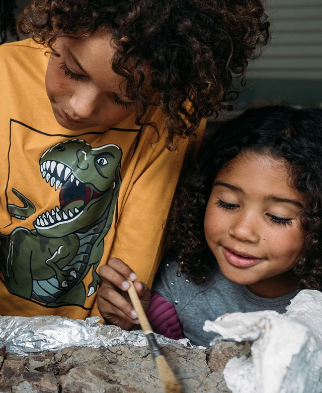 Children dig for dinosaur bones and petrified wood at Baisch's Dinosaur Dig in Glendive, Montana.