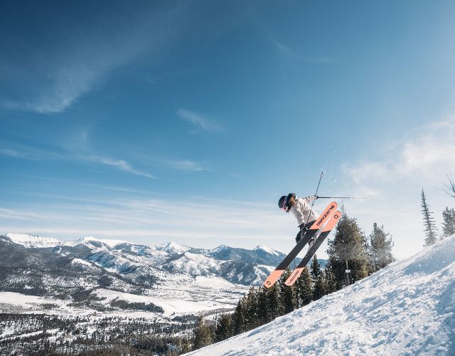 Skier jumps on a bluebird day at Maverick Mountain